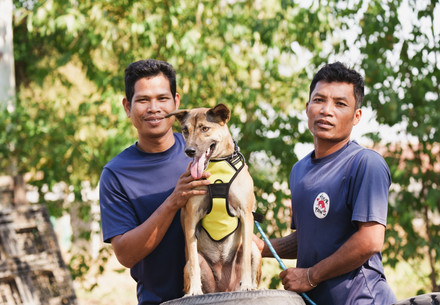 Two shelter staff members with rescued dog 