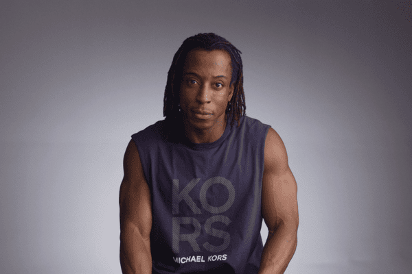 Actor Shaka Smith sitting in front of gray background