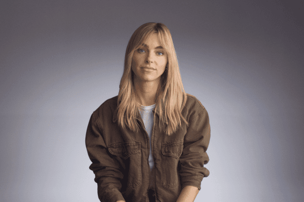 Model Elizabeth Turner sitting in front of gray background